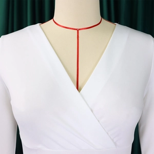Close-up of white V-neck sheath dress with premium knitting and professional tailoring