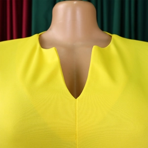 Close-up of bright yellow V-neckline dress with fine horizontal texture on fabric