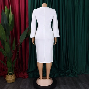 Rear view of white long sleeve pencil dress featuring invisible zipper and back slit detail