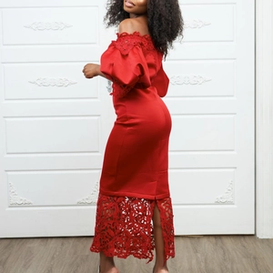 Detail of red off-shoulder evening dress with floral lace stitching and puff sleeves