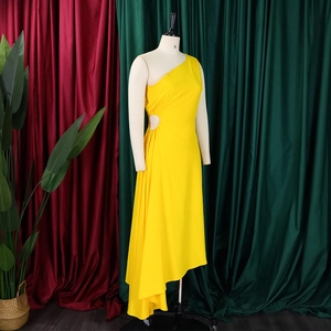 Detail view of bright yellow one-shoulder dress with side cutout and asymmetrical hemline
