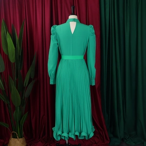 Detailed back view of green puff sleeve top and pleated skirt set with button closure