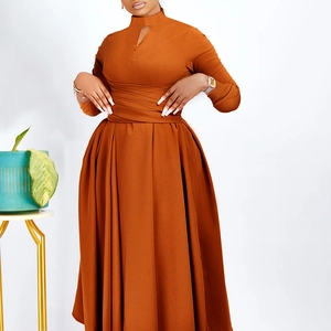 Detailed view of amber pleated maxi dress with elegant cut-out neckline and belted waist