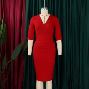 Detail of red V-neck sheath dress with waist pleats on a professional mannequin