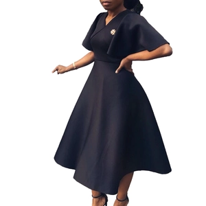 Detail of elegant V-neck midi dress featuring layered cape sleeves and a brooch accent