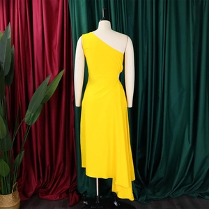 Detail of a bright yellow one-shoulder dress featuring an asymmetric hem and side ruffles