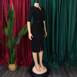 Detail of elegant black pencil dress featuring a V-neckline and gold ring belt buckle