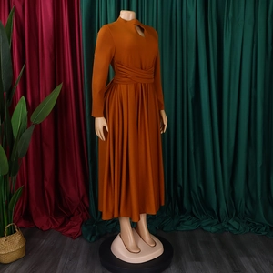 Detail of caramel pleated dress featuring a chic high neckline and wrap-around wide waistband