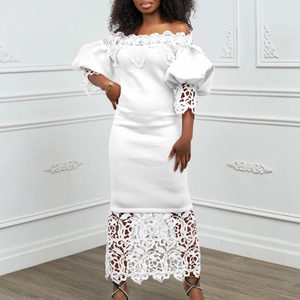 Close-up of elegant white off-shoulder dress with lace embroidery and lantern sleeves