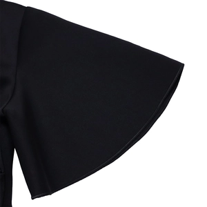 Close-up detail of the elegant black flare sleeves with premium stitching on the dress