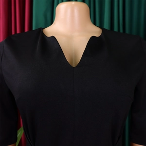 Close-up of elegant V-neck notch design on a black pencil dress for formal office wear