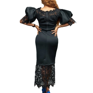 Detailed back view of a black evening dress featuring puff sleeves and lace trim detail