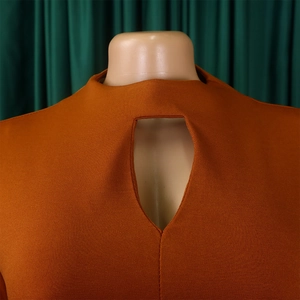Detail of high neck keyhole cutout and caramel knitted fabric on a maxi dress