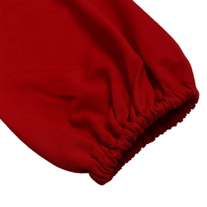 Detail view of the red long-sleeved dress showing elasticated cuffs and knitted fabric texture