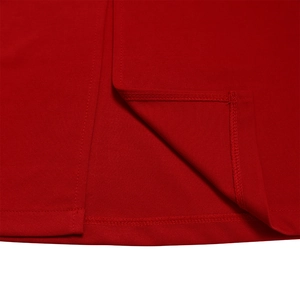Detailed close-up of high-quality double-needle stitching on a red knit dress hem