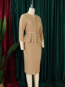 Detail of camel two-piece dress set featuring ruffled top hem and pleated midi skirt texture