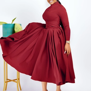 Detail of elegant wine red pleated maxi dress with long sleeves and high neckline