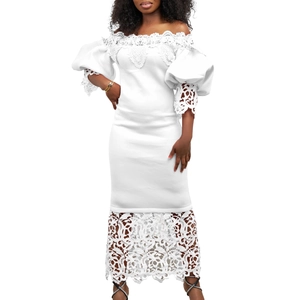 Detail of white lace off-shoulder dress featuring bubble sleeves and intricate floral embroidery