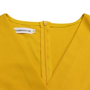 Close-up of V-neckline with invisible zipper on ginger yellow textured dress