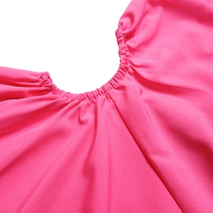 Detail of rose red dress showing elastic pleated neckline and smooth fabric texture