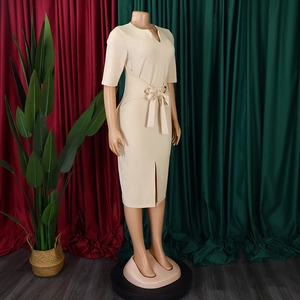 Detail of elegant V-neck beige midi dress with waist tie and gold ring buckle feature