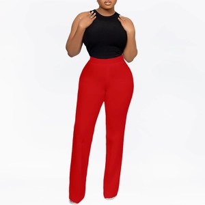 Detail of high-waisted vibrant red wide-leg trousers with elastic fit and sleek silhouette