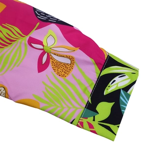 Detail of floral shirt cuff with tropical leaf prints and white contrast topstitching