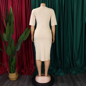 Rear view of beige V-neck pencil dress featuring a hidden zipper and fitted silhouette