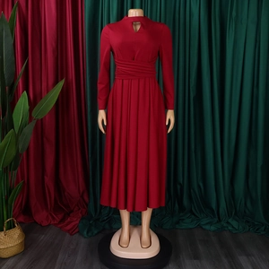 Detail of red pleated midi dress featuring high neck hollow out and waist cinching