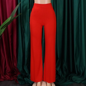 Detail view of high-waisted wide-leg trousers in vibrant red fabric with draped texture