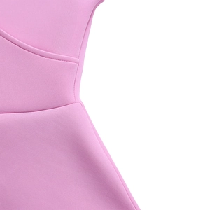 Detail of the pink dress featuring a V-neck wrap design and high-quality stitching texture