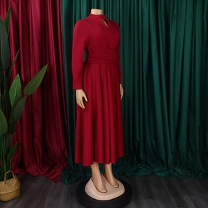Close-up of wine red long sleeve dress featuring waist pleats and teardrop neckline