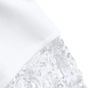 Detailed macro shot of fine floral lace embroidery on elegant white fabric lantern sleeves