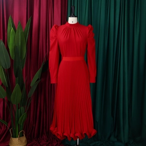 Detailed view of red puff sleeve top and pleated skirt set with ruffled hem finish
