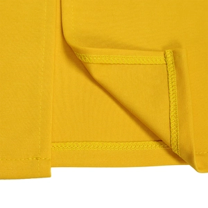 Detail view of the fine stitching and flat seams on the bright yellow dress hemline