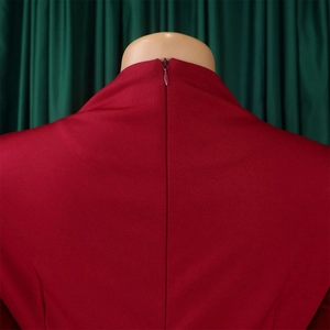 Detail view of red high collar dress featuring a concealed back zipper and smooth fabric