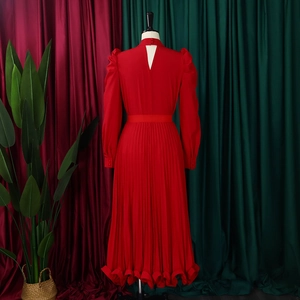 Detailed back view of red pleated dress showing keyhole cutout and puffed sleeves