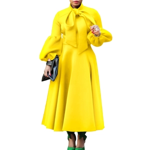 Detail of elegant lantern sleeves and high-neck bow tie on a bright yellow A-line dress