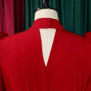 Close-up of red top back detail with stand collar, buttons and stylish V-cutout