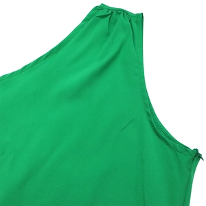 Detail of green one-shoulder dress showing pleated shoulder and side zipper