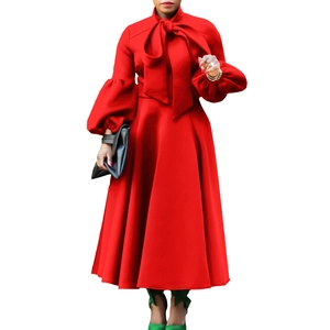 Detail of red lantern sleeve dress with pussy-bow neck and high waist flare skirt