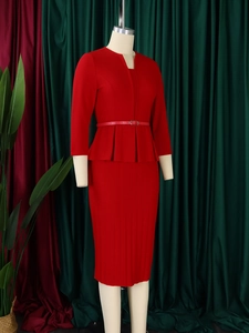 Detail view of red peplum top and pencil skirt with a metal buckle belt and V-neckline