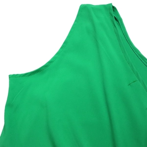 Detail of lime green sleeveless dress showing professional stitching and smooth fabric texture