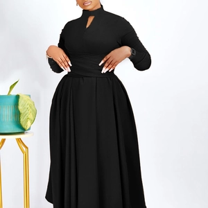 Detail view of the pleated waist and keyhole neckline on this black long sleeve dress