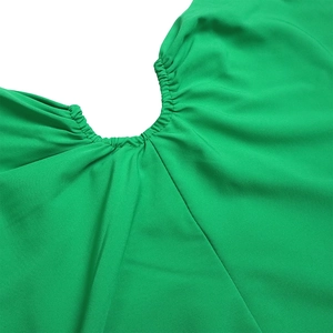 Detail of gathered elastic neckline on bright green one-shoulder dress fabric