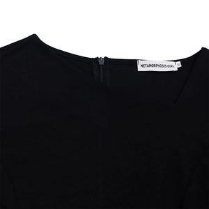 Detail of asymmetrical neckline on a black knit dress with a hidden zipper and size M label