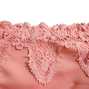 Detailed view of pink floral embroidery lace on the neckline of the evening dress
