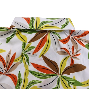 Close-up of tropical leaf print shirt collar and smooth polyester fabric texture