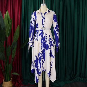Detail view of the long sleeve floral print shirt dress with irregular hem and belted waist