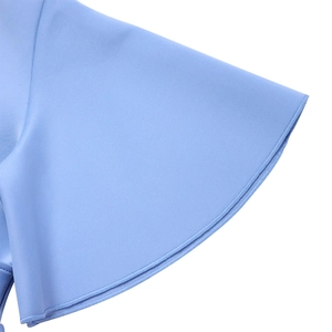 Macro shot of sky blue flare sleeve cuffs with fine edge stitching and smooth fabric texture